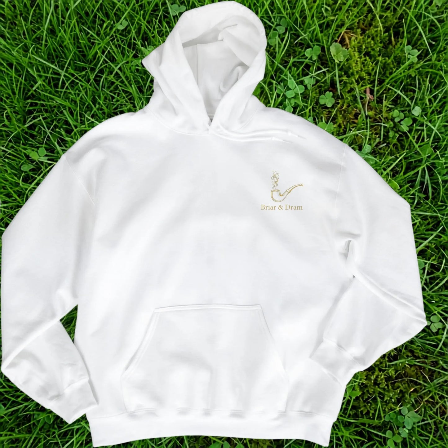 White hooded sweatshirt with gold pipe graphic and "Briar & Dram" text.