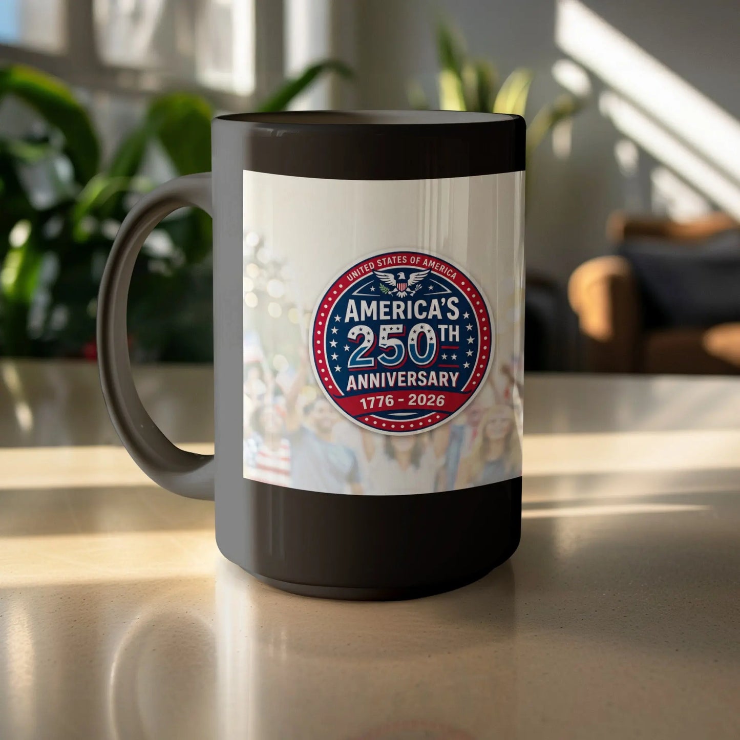 Black mug with America's 250th Anniversary 1776-2026 logo and blurred crowd background.