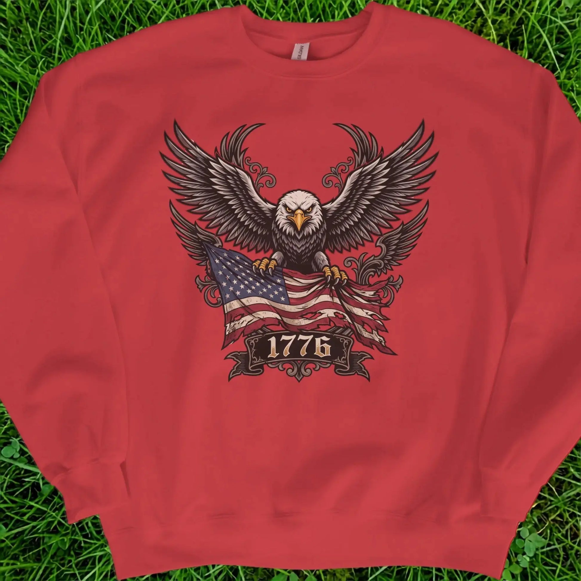 Red crewneck sweatshirt with eagle, American flag, and "1776" text graphic.