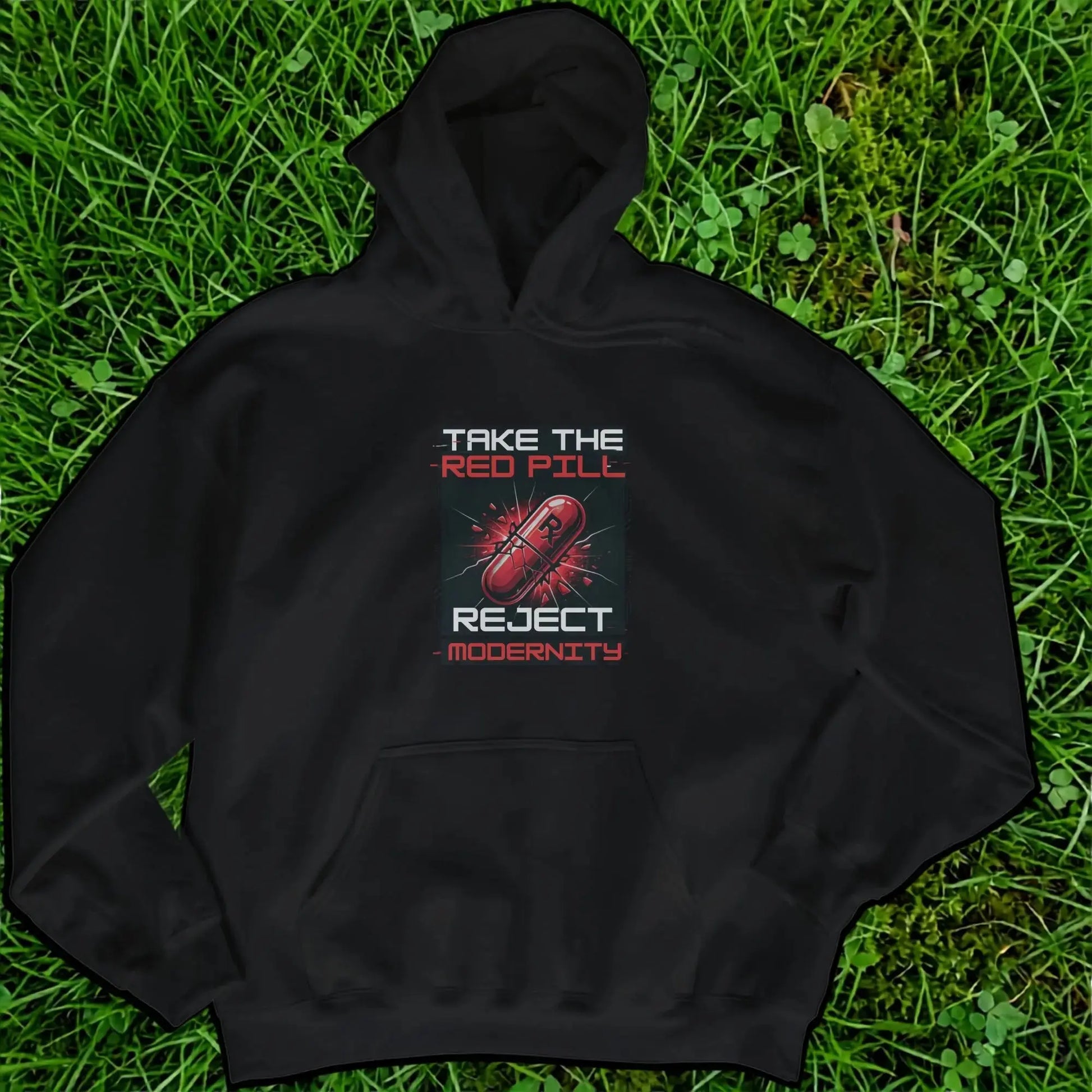 Black hoodie with a graphic of a broken red pill and text "TAKE THE RED PILL REJECT MODERNITY."