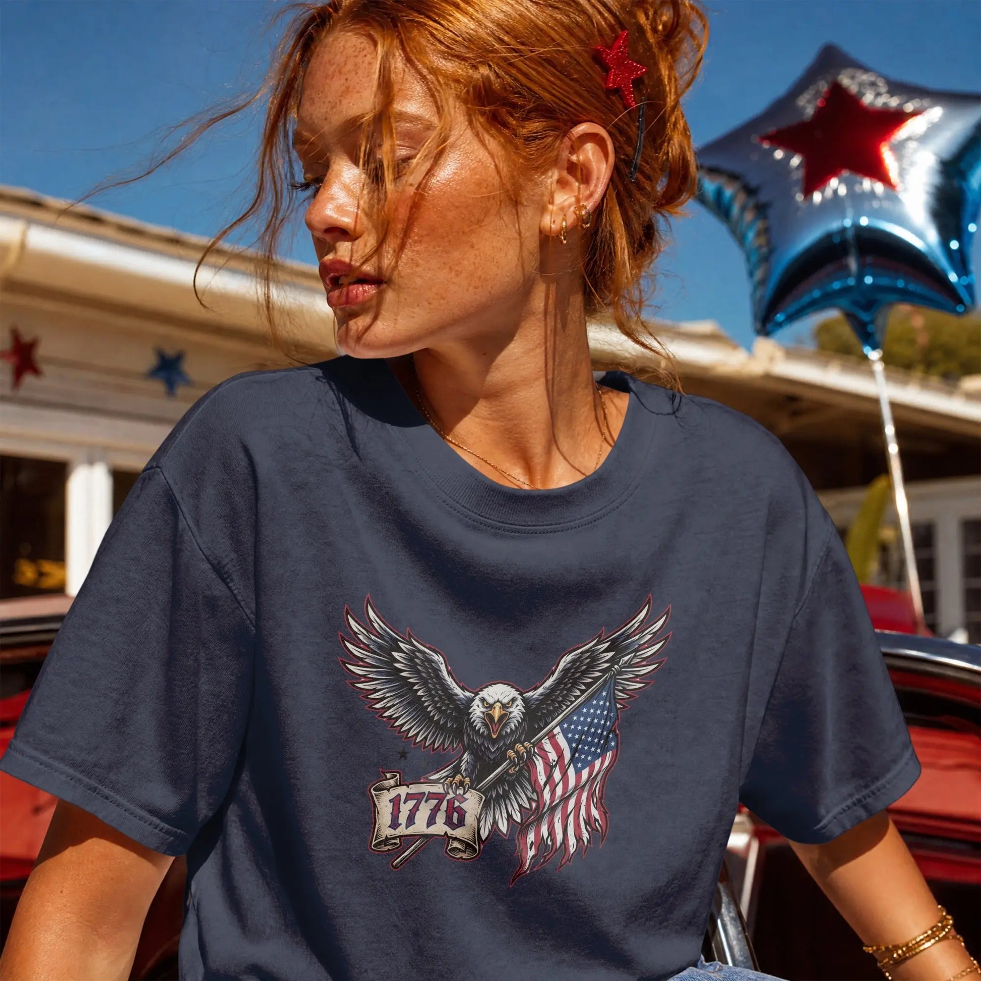 Navy t-shirt with eagle holding American flag and "1776" banner graphic.
