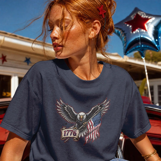 Navy t-shirt with eagle holding American flag and "1776" banner graphic.