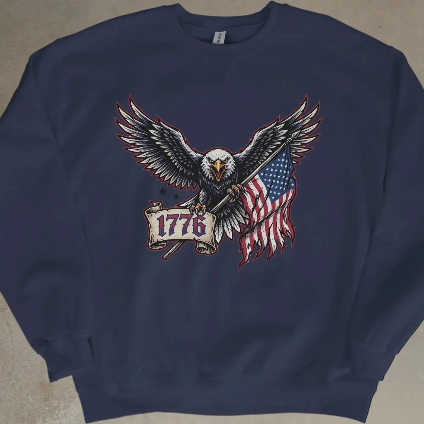 Eagle holding American flag and banner with "1776" on navy blue sweatshirt.