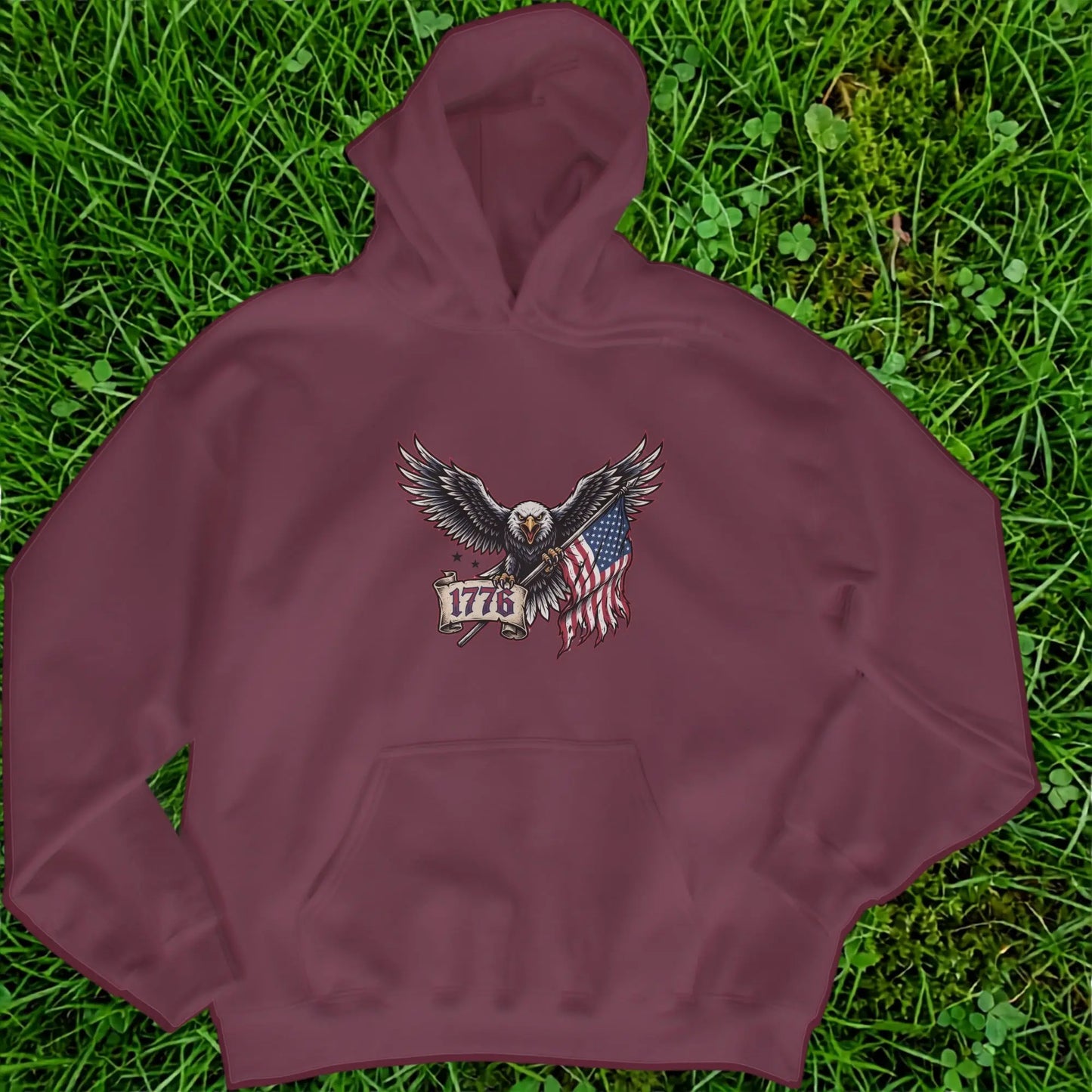 Maroon hoodie with eagle, American flag, and "1776" text printed on the front.