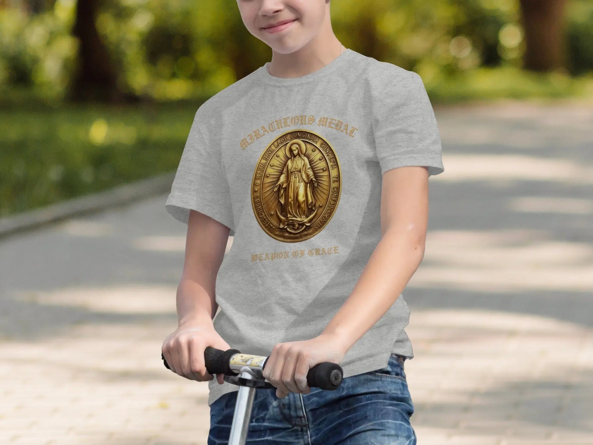 Grey t-shirt with Miraculous Medal design and "Weapon of Grace" text.