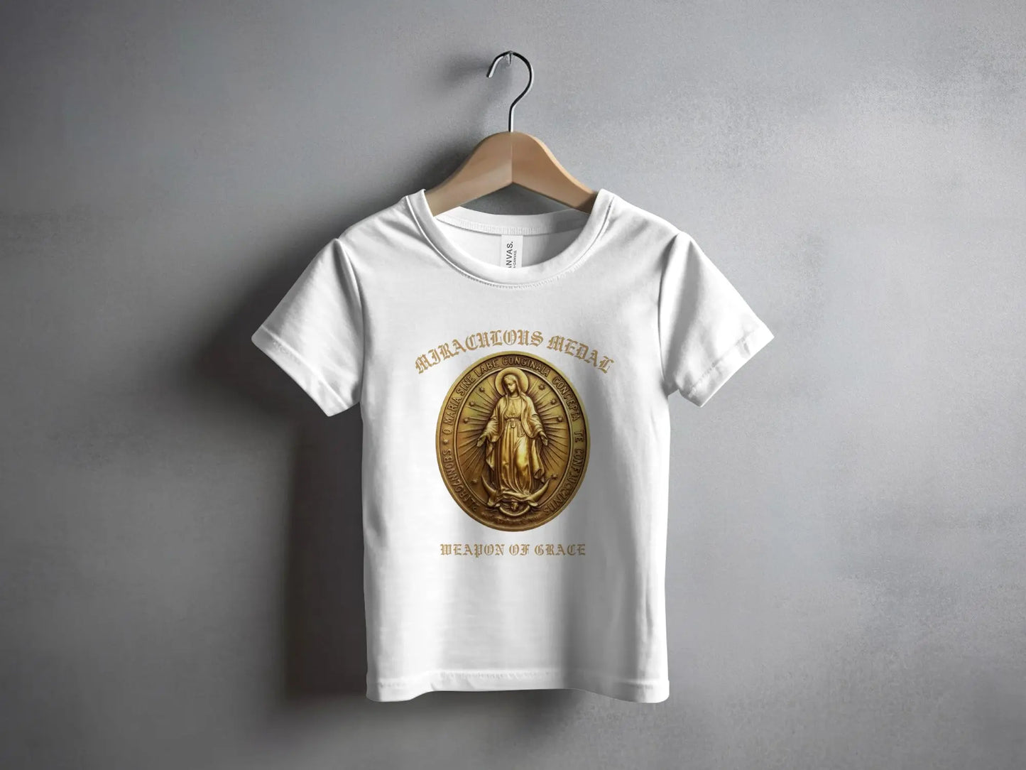 White t-shirt with a Miraculous Medal design and "WEAPON OF GRACE" text.