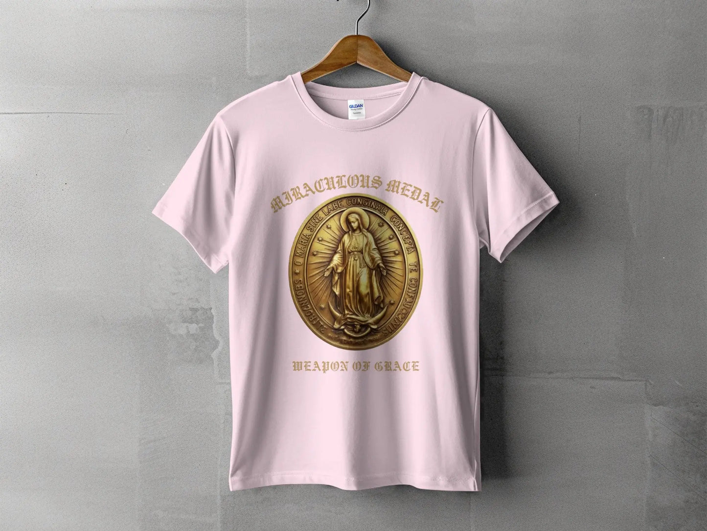 Pink t-shirt with "Miraculous Medal" design and "Weapon of Grace" text.