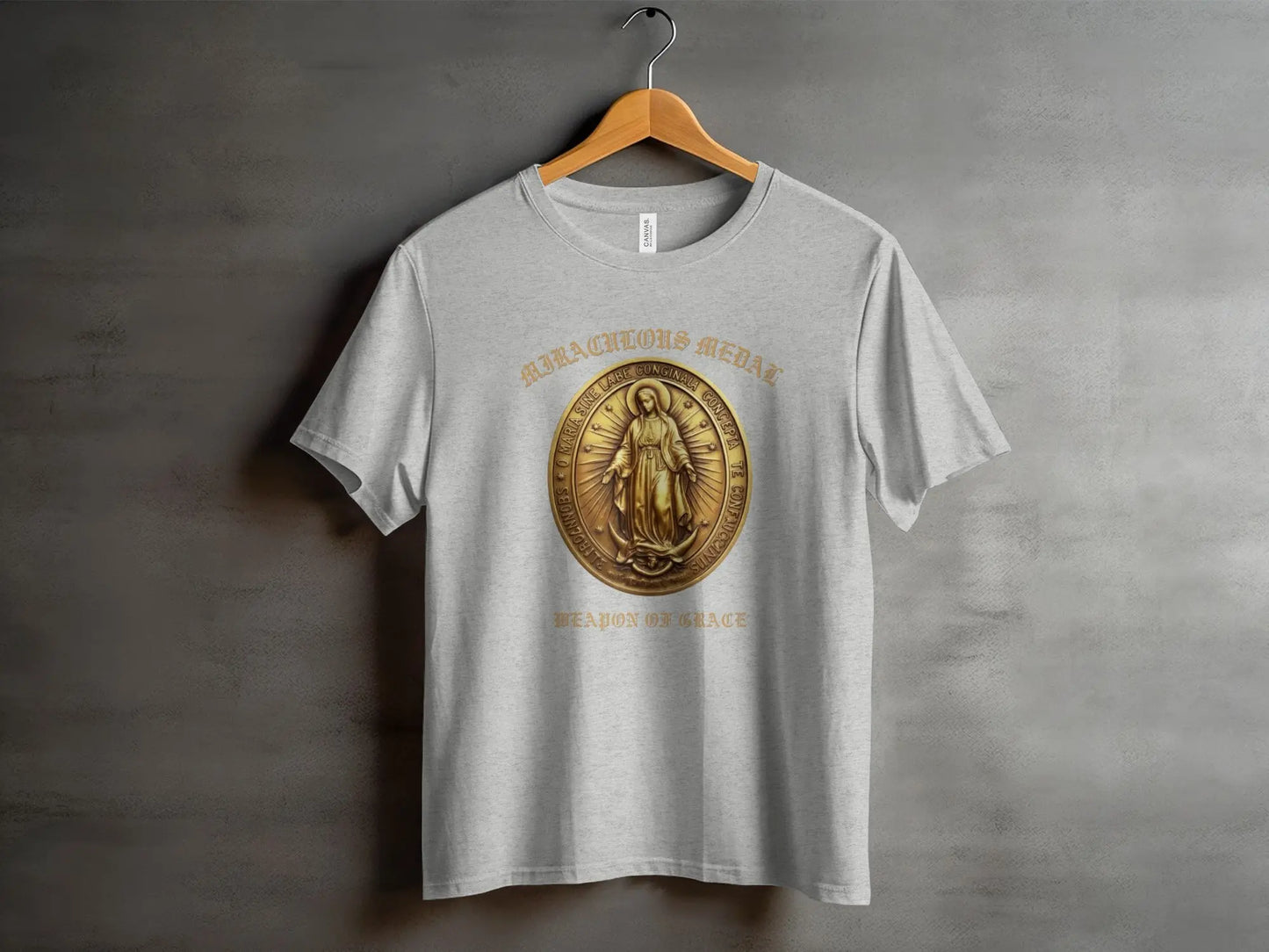 Grey t-shirt featuring a gold Miraculous Medal with text.