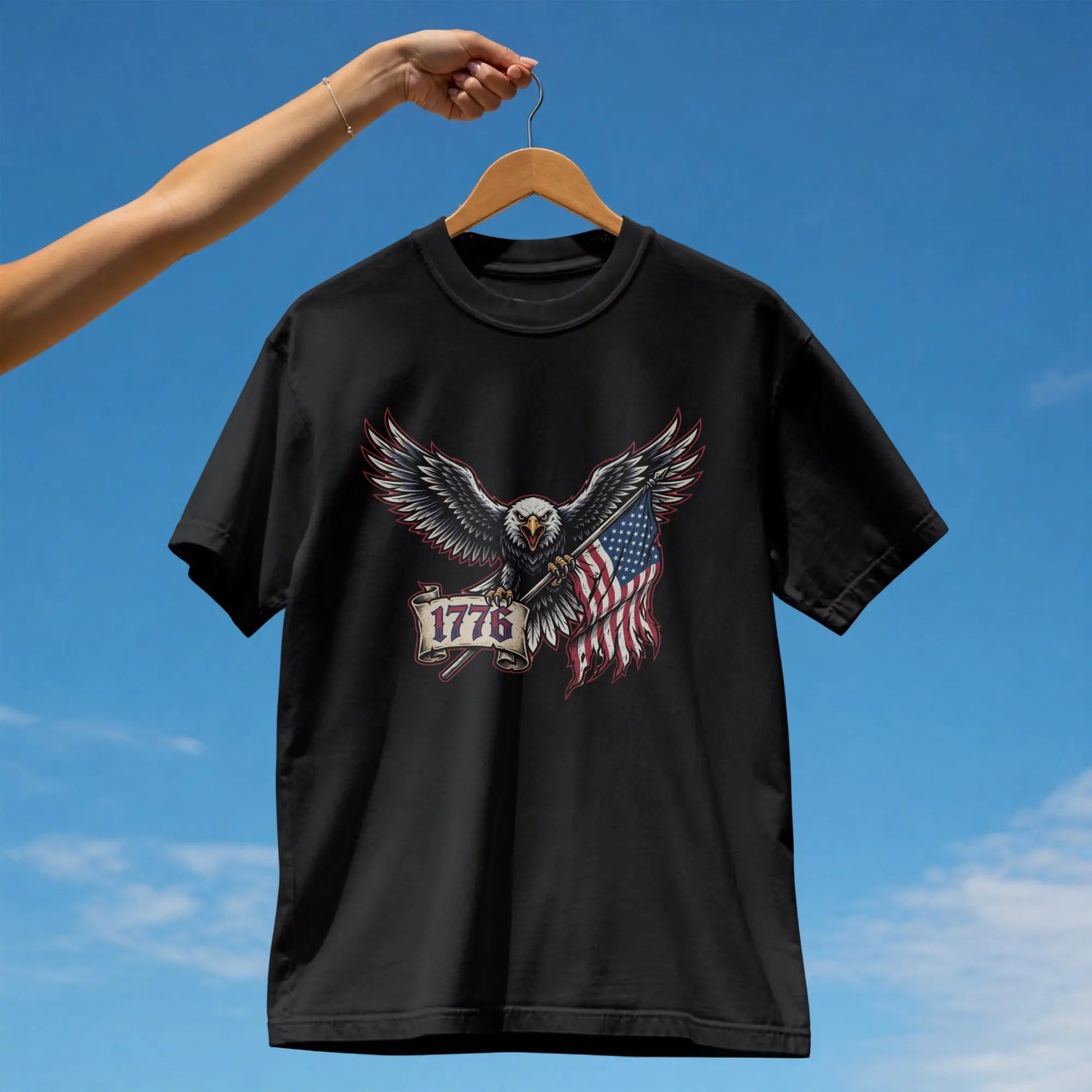 Black t-shirt with eagle holding American flag and "1776" banner.