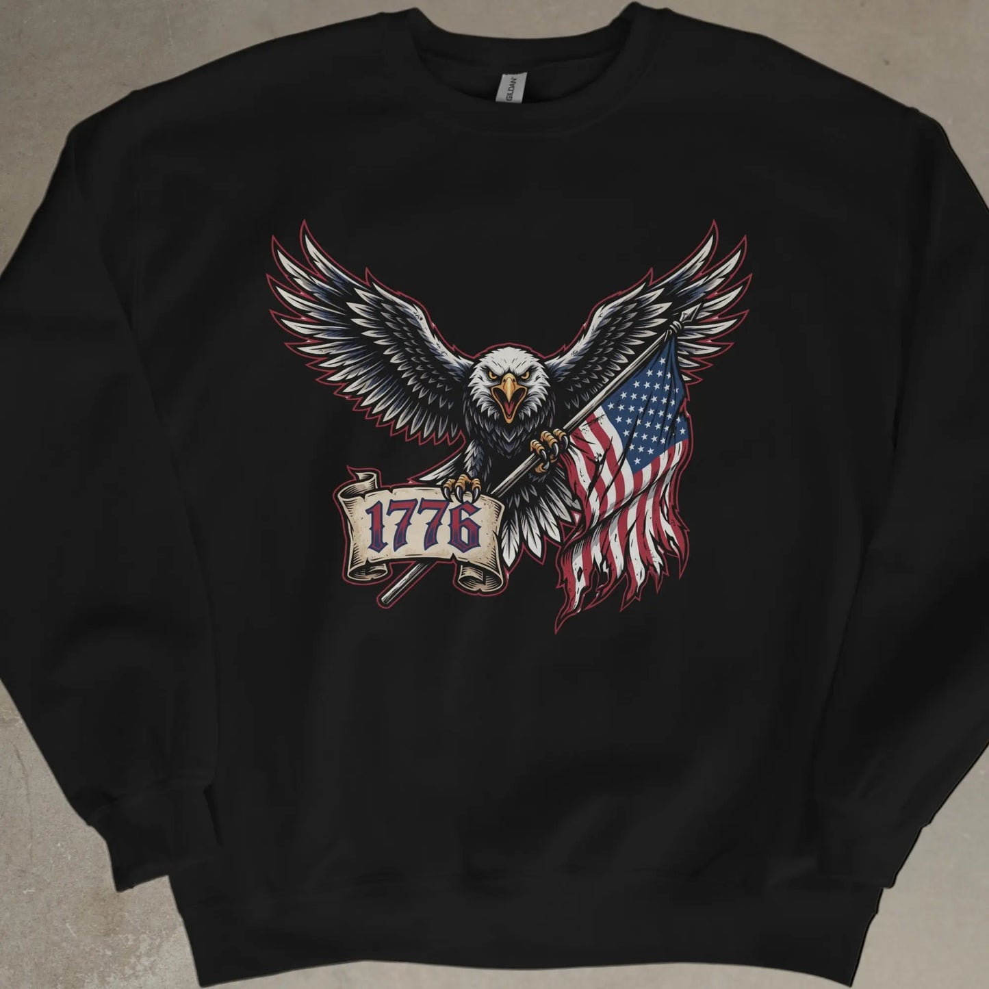Eagle holding American flag and "1776" banner on a black sweatshirt.