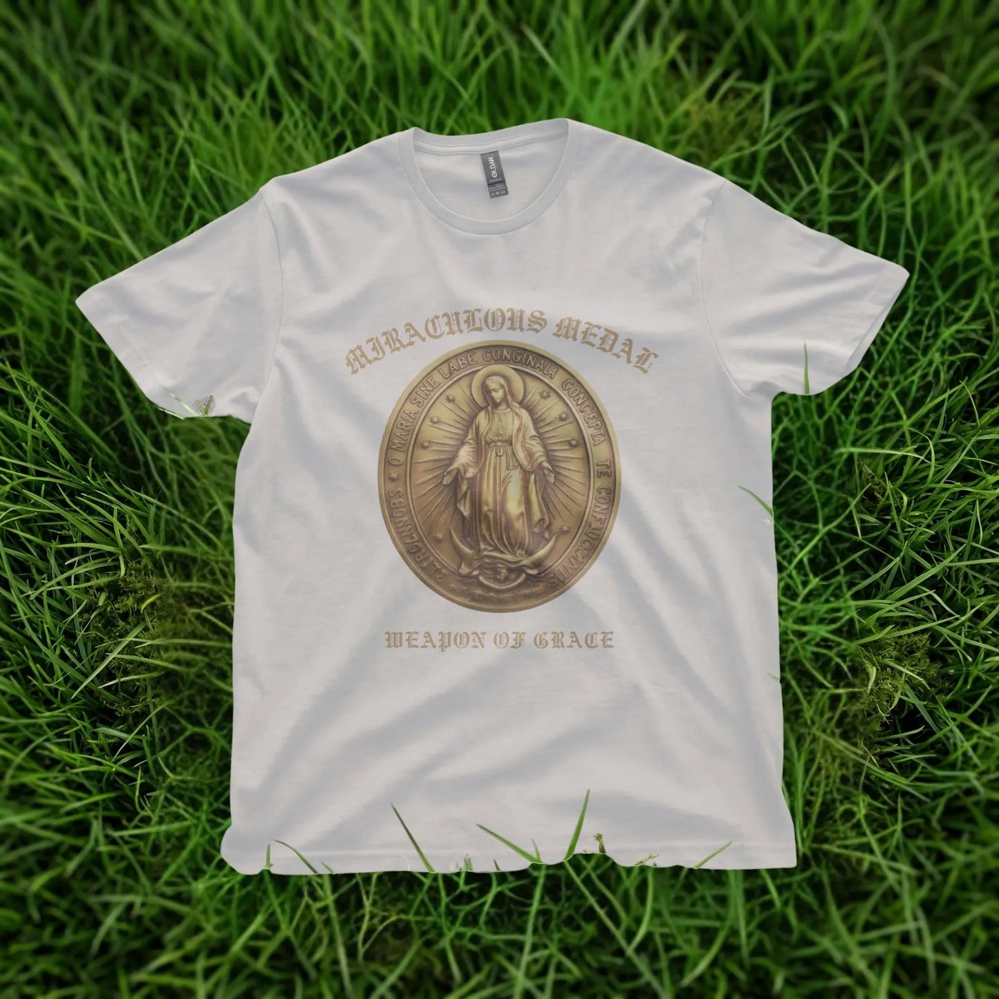 White t-shirt with "Miraculous Medal" and "Weapon of Grace" text and a medal graphic.