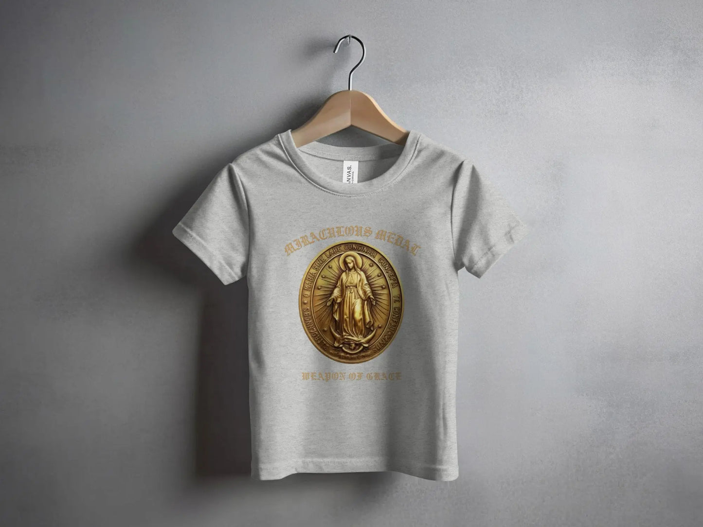 Light grey t-shirt featuring a gold Miraculous Medal design and "Weapon of Grace" text.