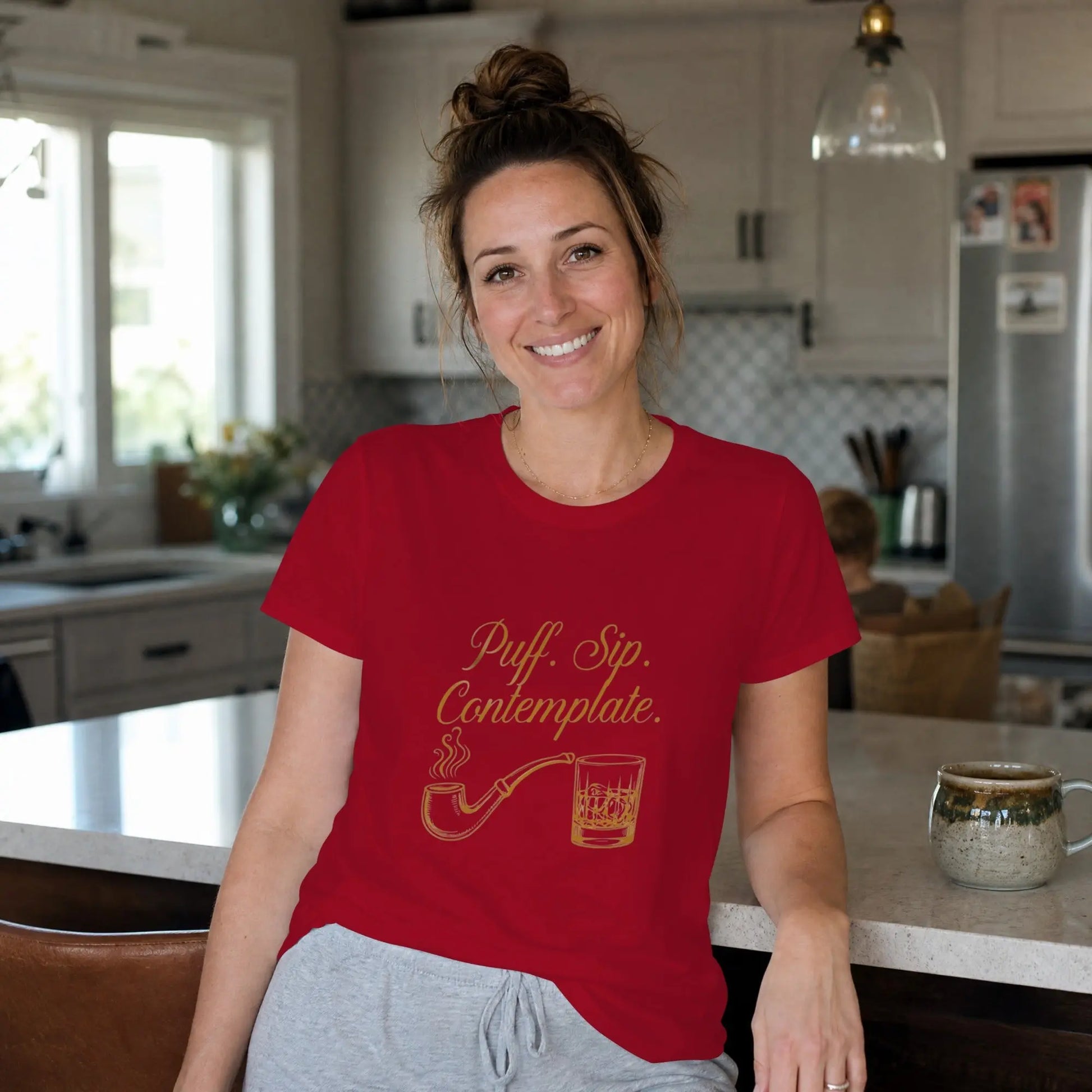 Red t-shirt with gold text "Puff. Sip. Contemplate." and pipe illustration.
