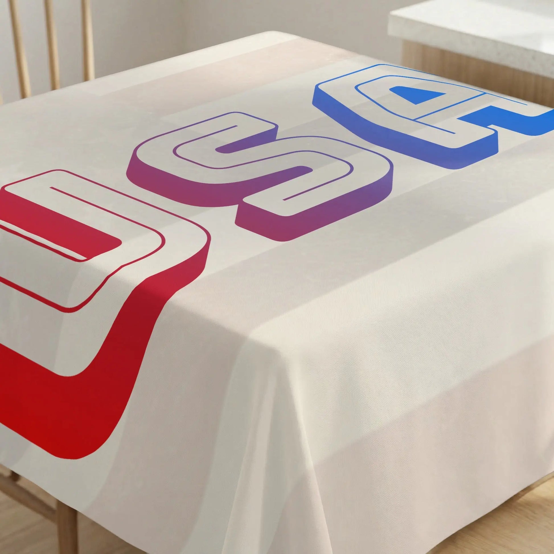Tablecloth with large red, purple, and blue 3D "USA" text design.