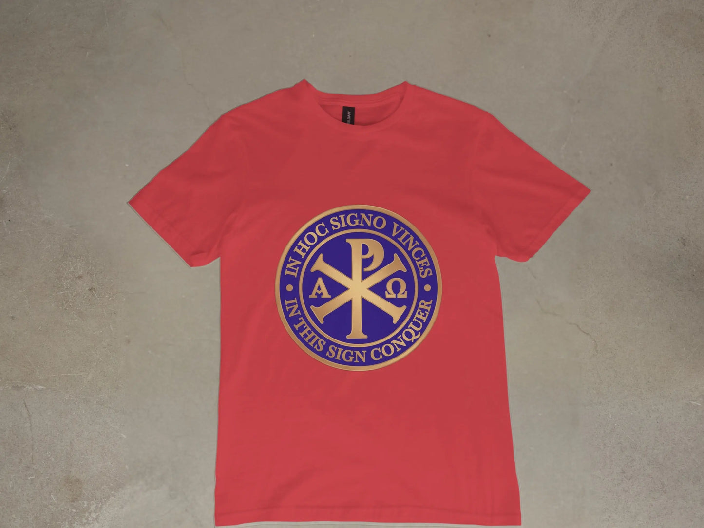 Red t-shirt with blue and gold Chi Rho emblem and Latin inscription.