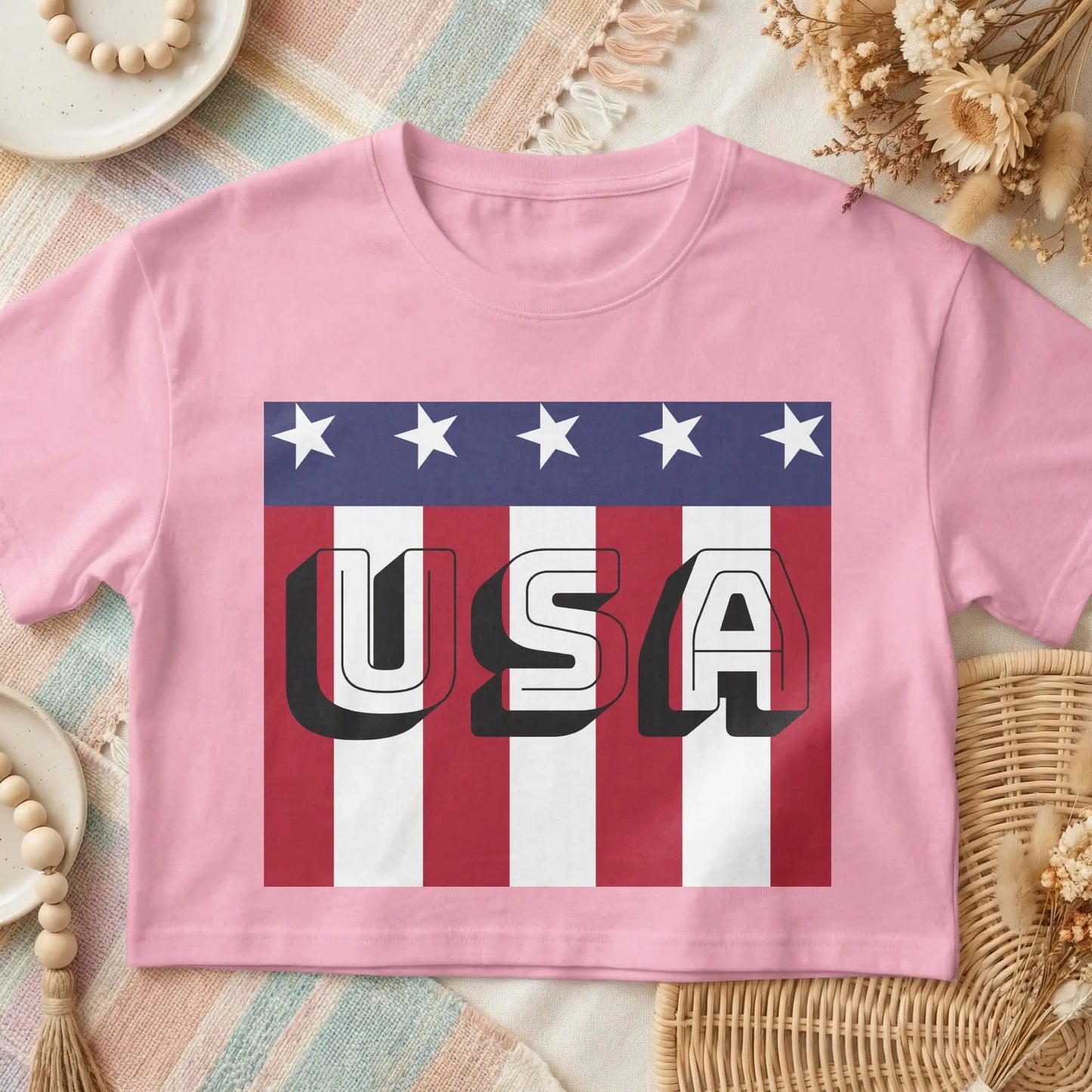 Pink crop top with "USA" text in bold, 3D white font over a flag design.