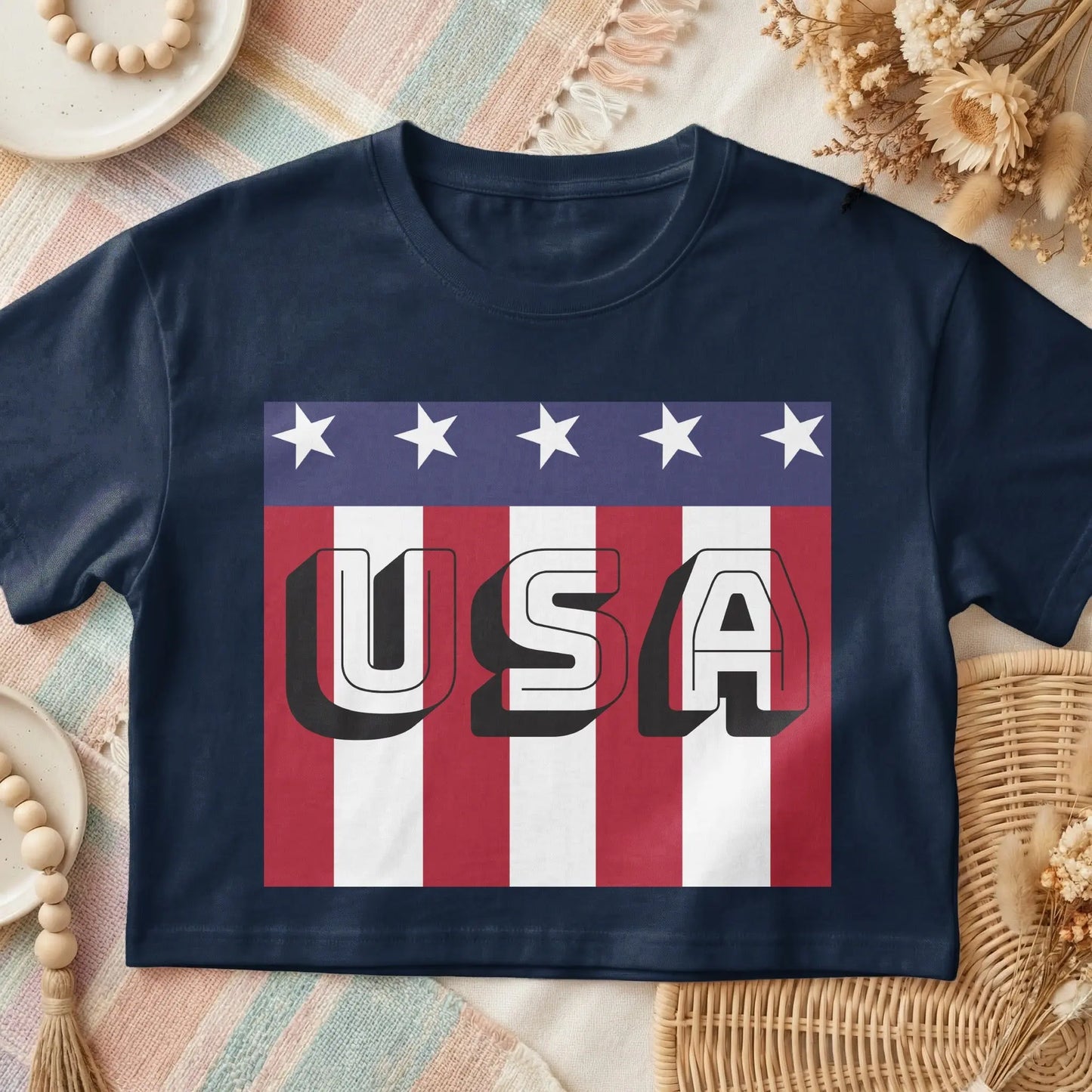 Navy t-shirt with bold "USA" text over American flag stripes and stars.