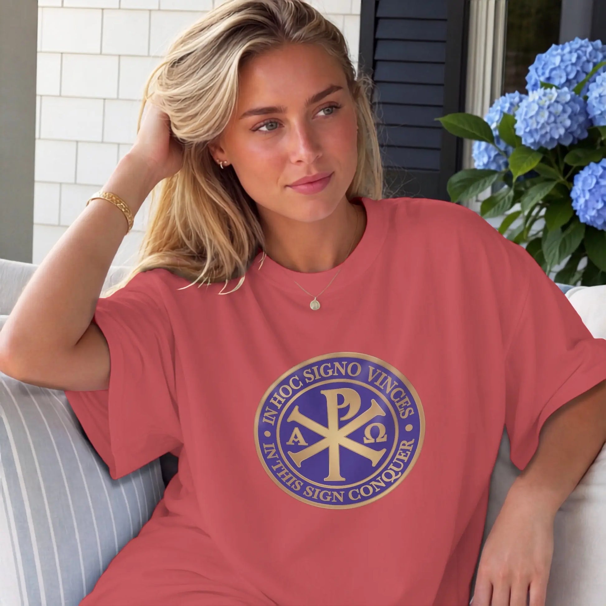 Coral t-shirt with gold Chi Rho logo and Latin text "In Hoc Signo Vinces."