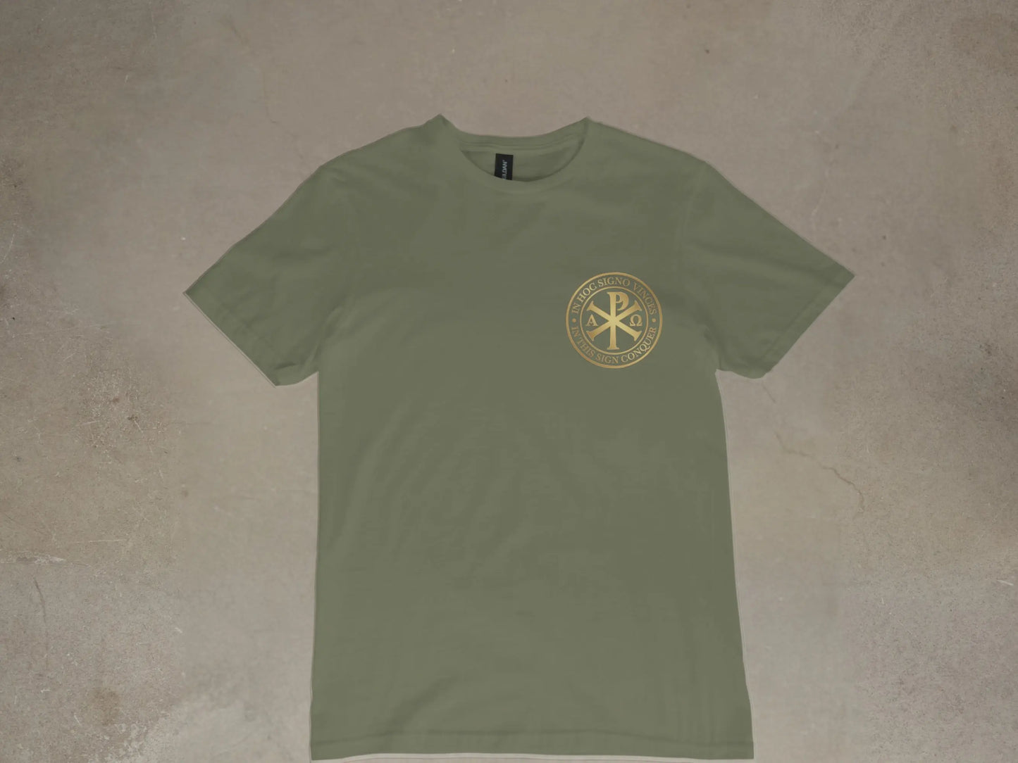Olive green t-shirt with gold Chi Rho and Latin text "In hoc signo vinces".