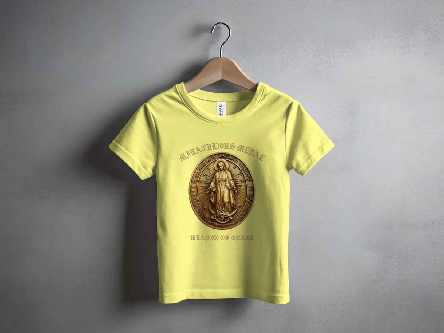 Yellow t-shirt with Miraculous Medal and "Weapon of Grace" text.