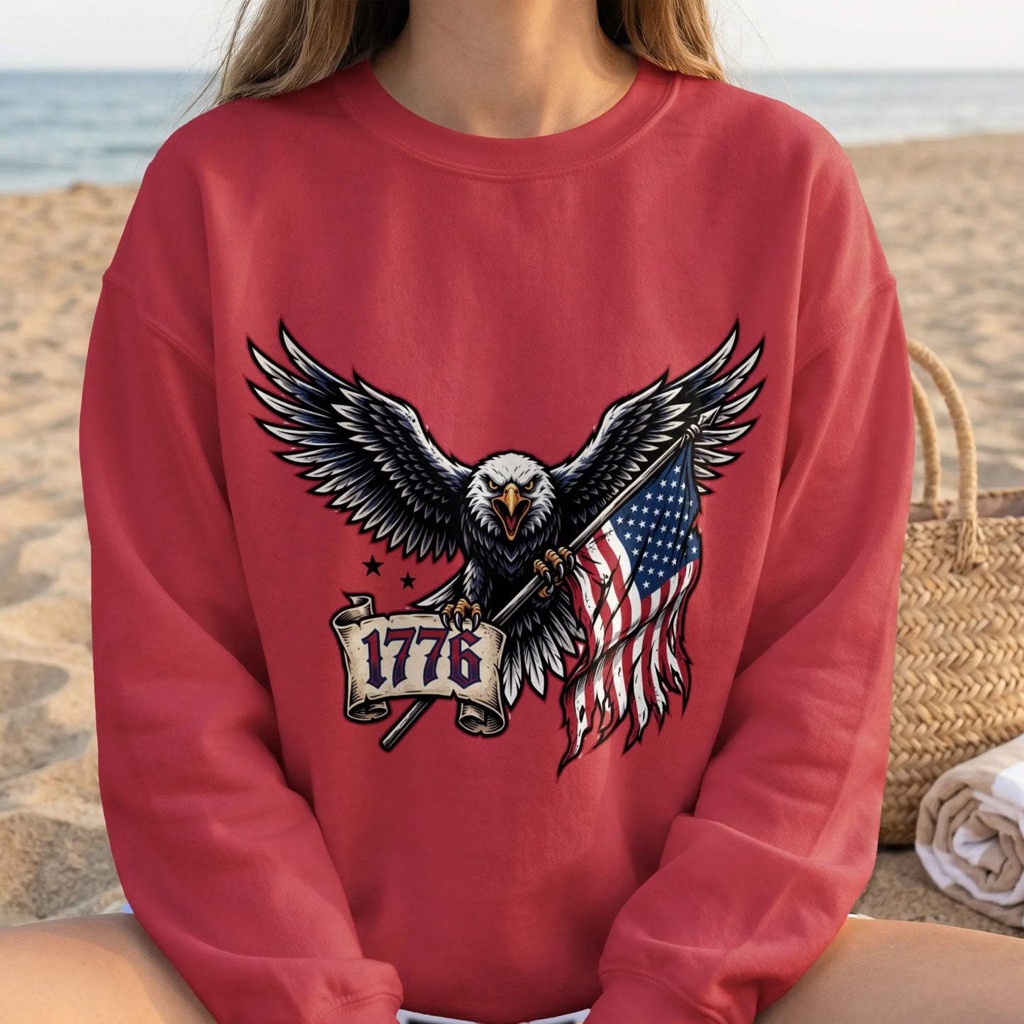 Red sweatshirt with eagle holding US flag and 1776 banner design.