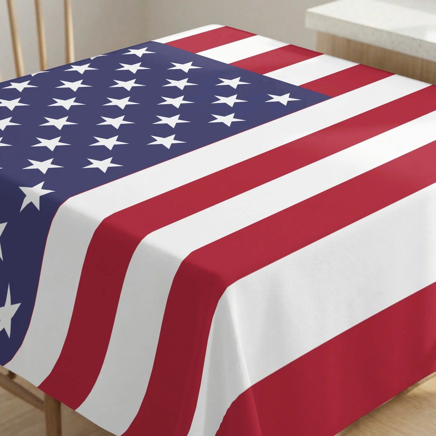 Tablecloth with American flag pattern, featuring stars and stripes draped over a table.