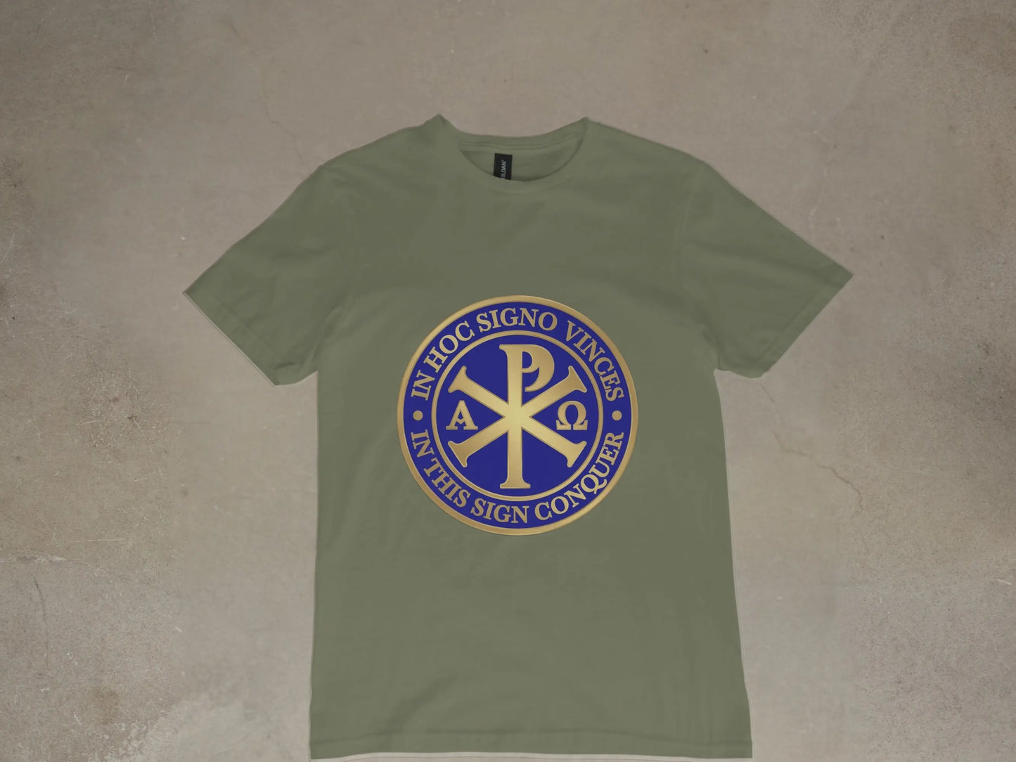 Olive green t-shirt with a gold and blue Chi Rho symbol and Latin text.