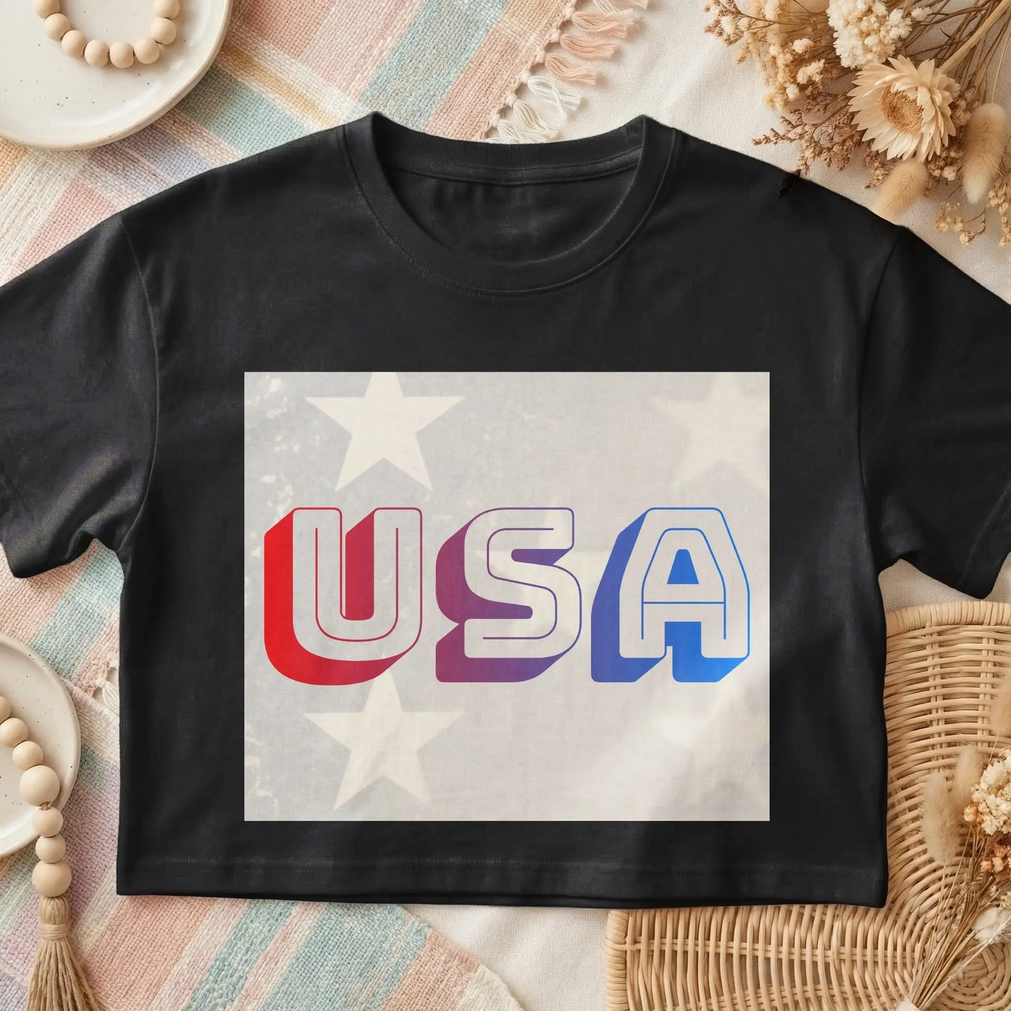 Black t-shirt with "USA" graphic featuring red, purple, and blue gradient letters on a speckled starry background.