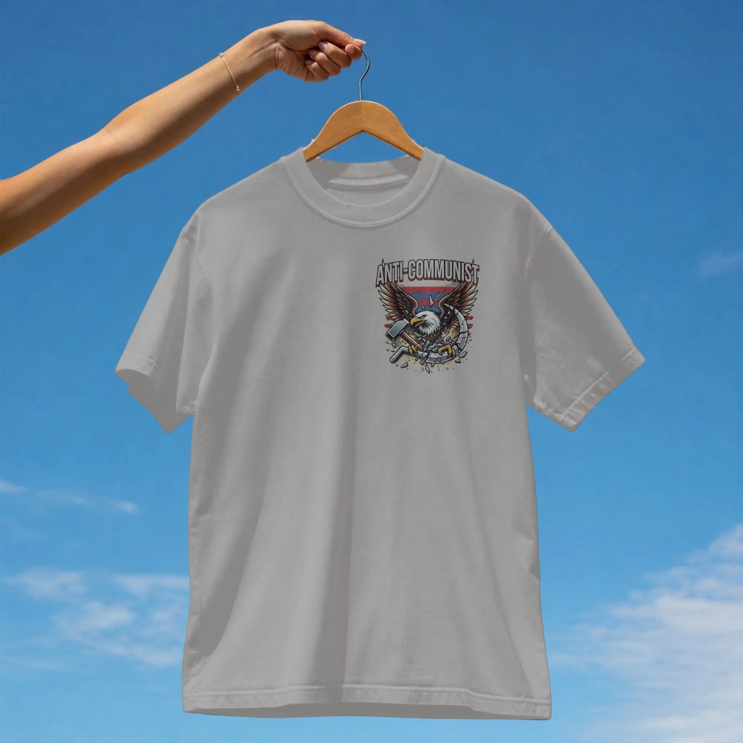 White t-shirt with graphic of eagle, hammer, and sickle against American flag.