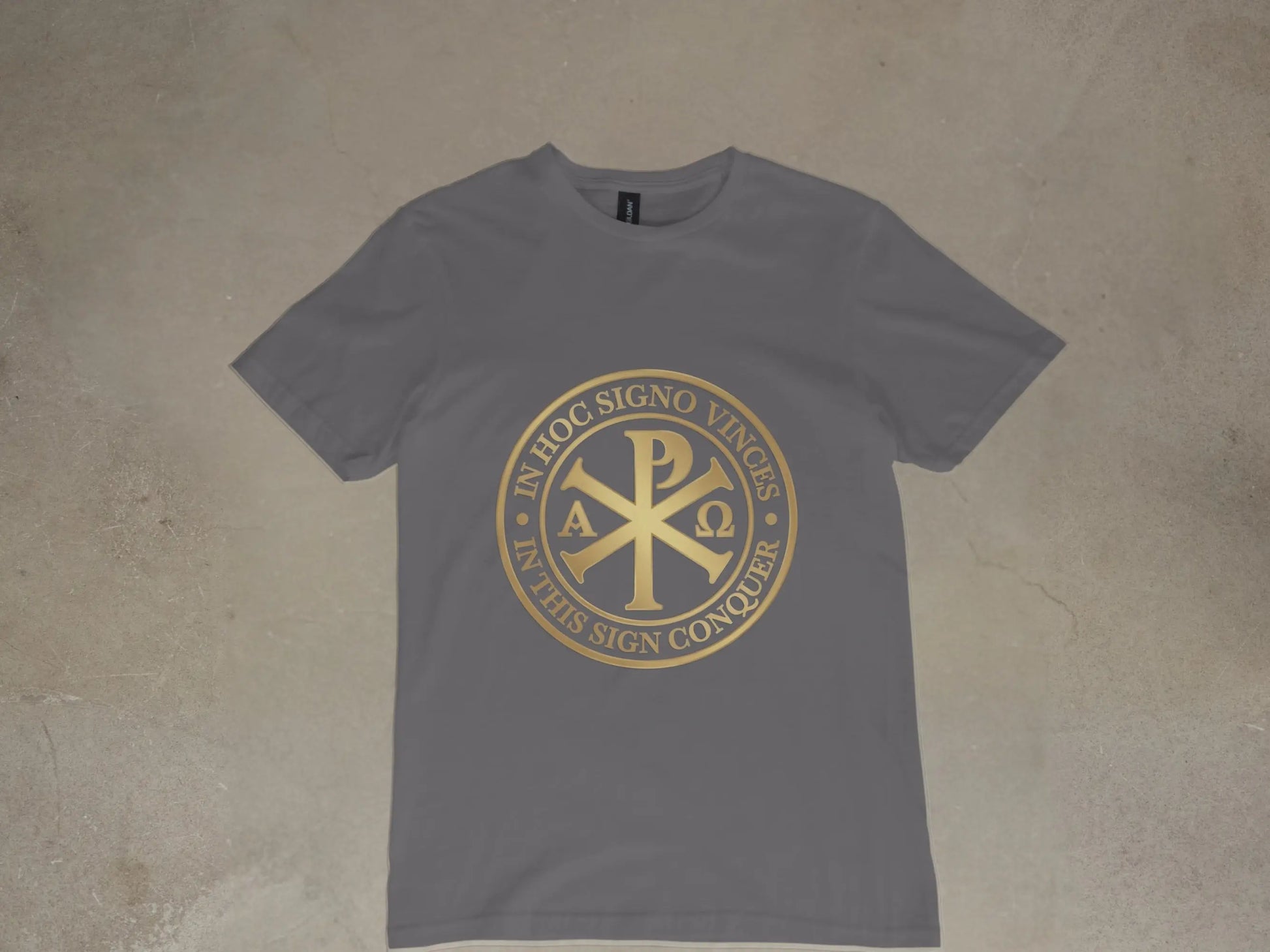 Grey t-shirt with gold Chi-Rho symbol and Latin text "In Hoc Signo Vinces".