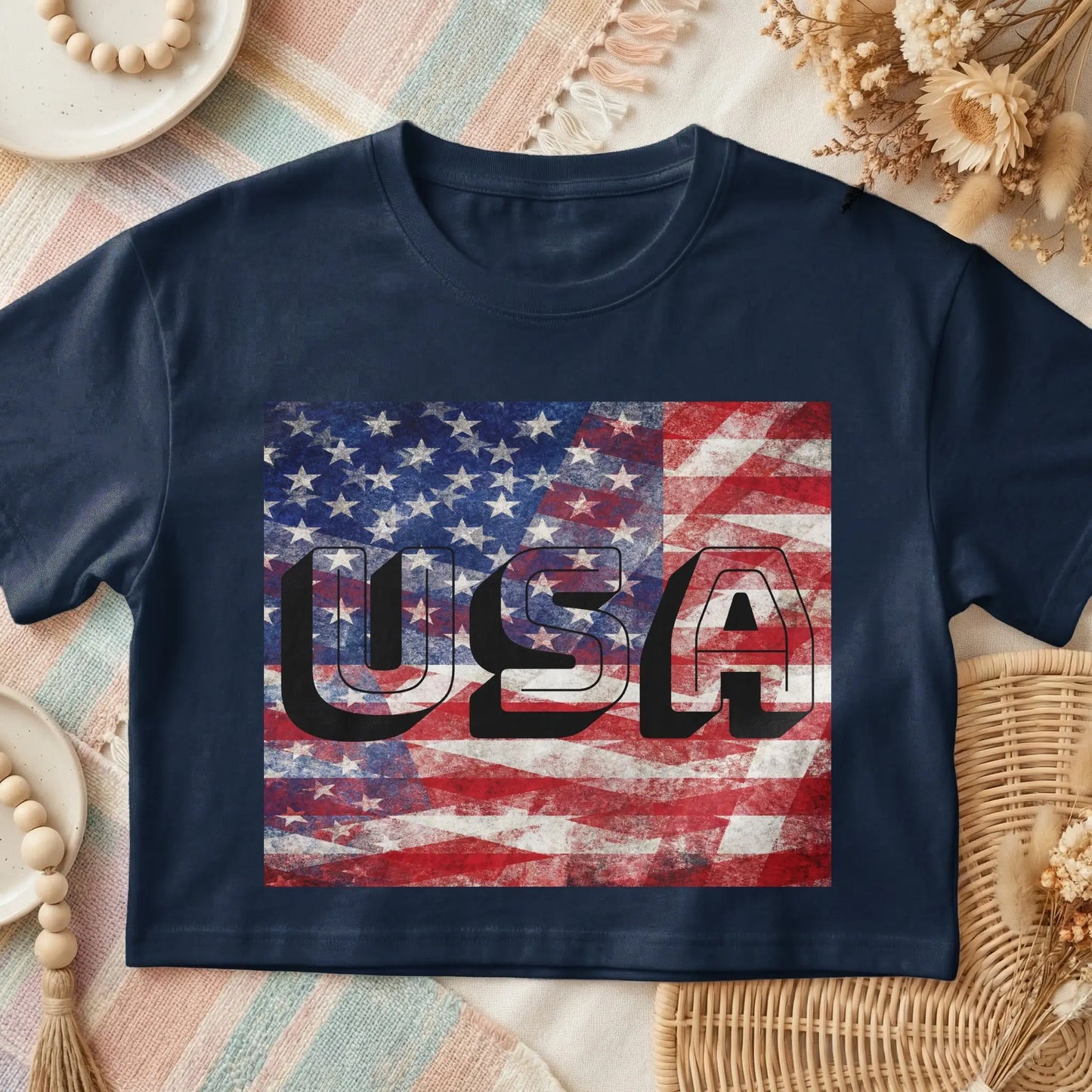 Navy t-shirt with distressed USA flag graphic and bold black lettering.