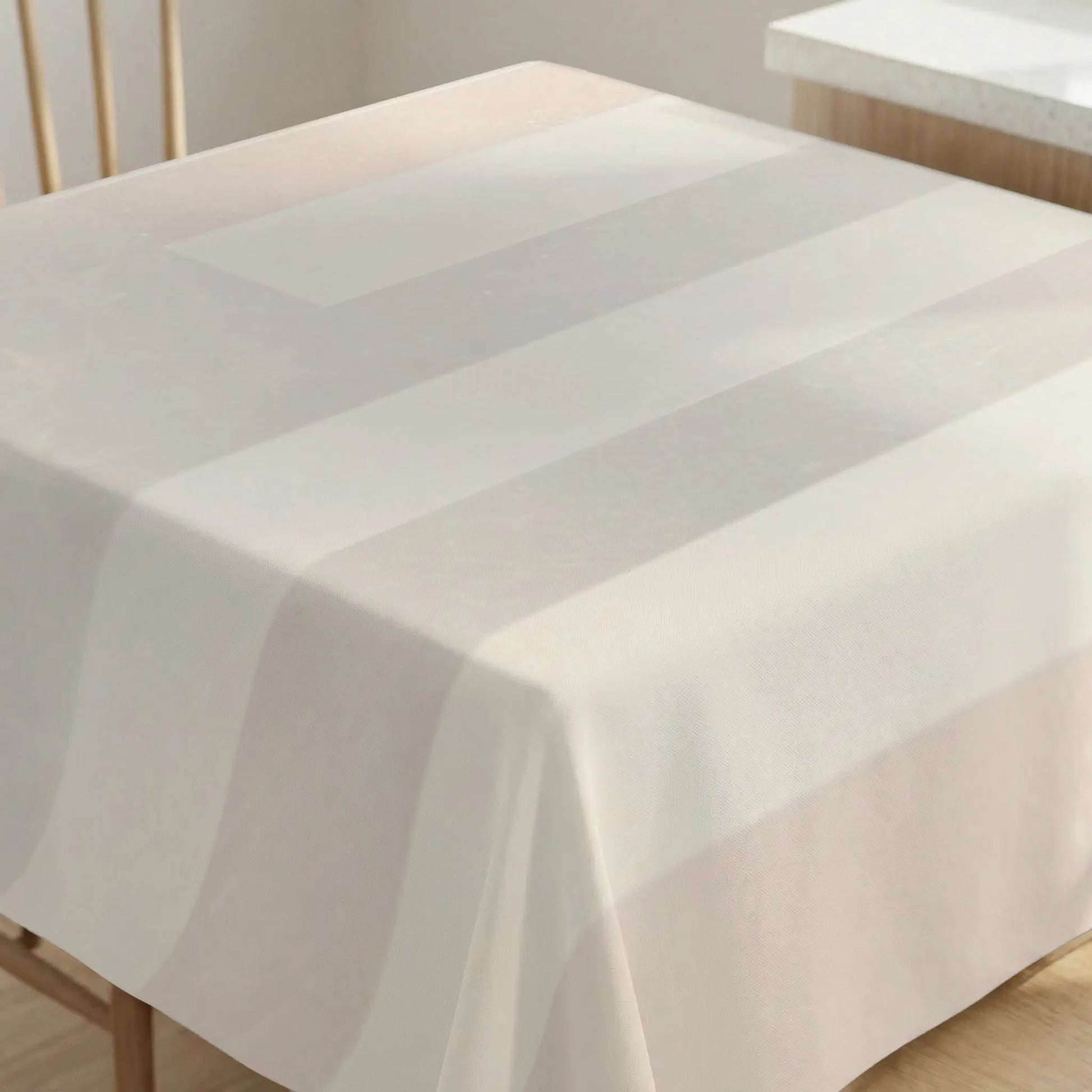 Soft striped tablecloth in off-white and beige draped over a table.