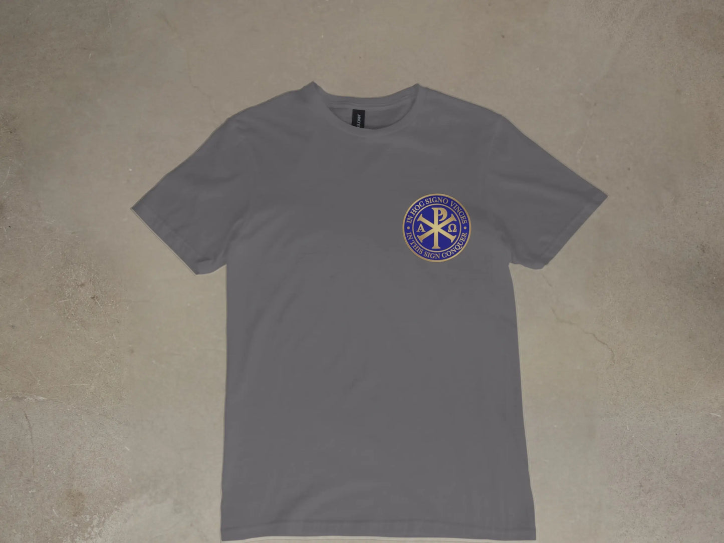 Grey t-shirt with gold and blue circular emblem featuring Chi Rho and text.