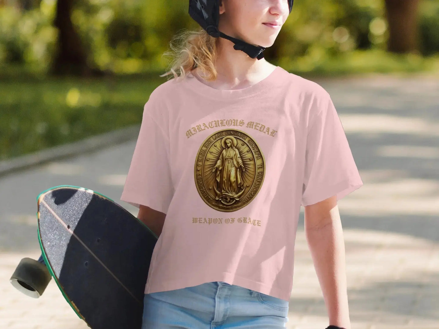 Pink t-shirt with gold Miraculous Medal and "Weapon of Grace" text.