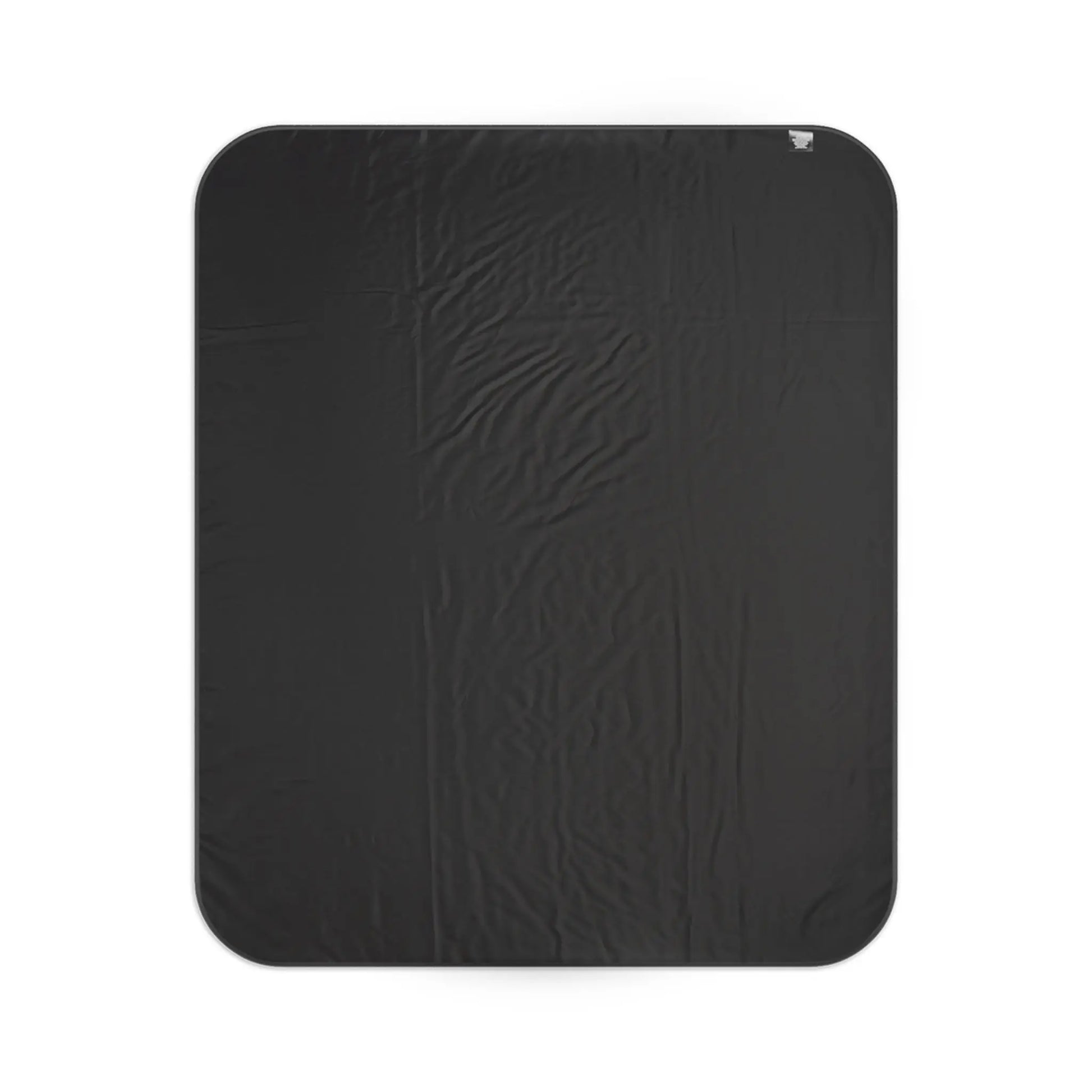 Black textured blanket with rounded corners and a small fabric tag.