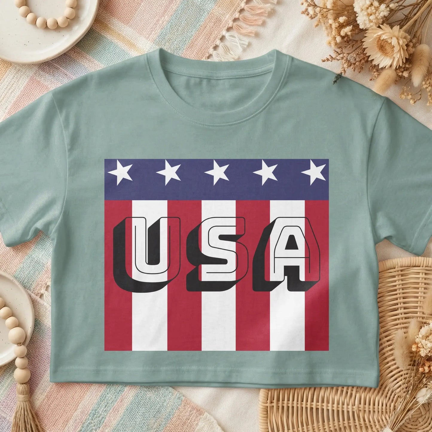 Light blue t-shirt with a bold "USA" graphic on a distressed American flag background.