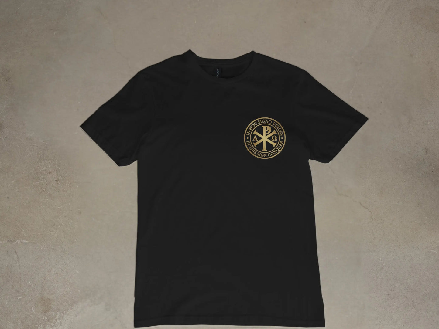 Black t-shirt with gold circular emblem featuring Chi-Rho and Latin text.