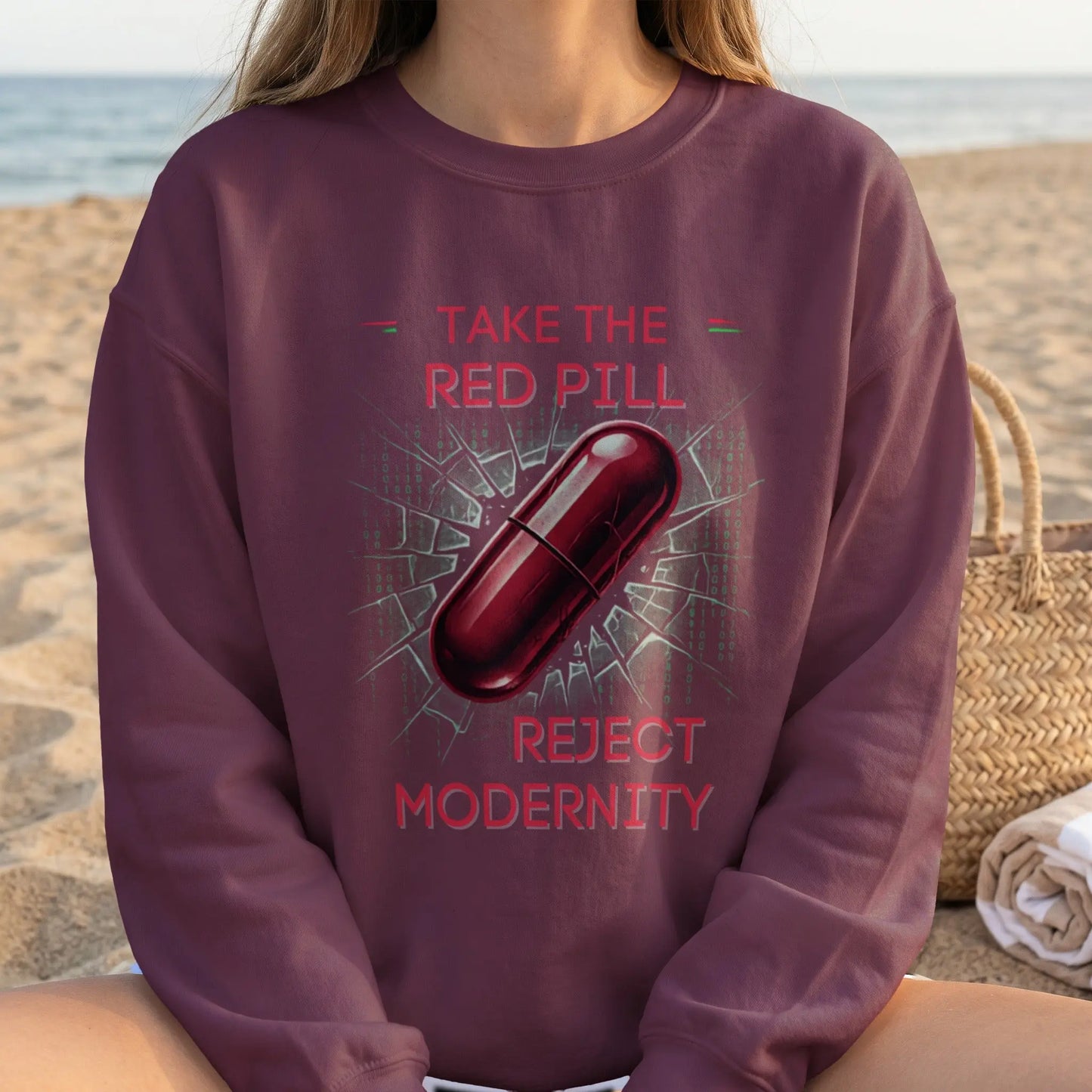 Red pill graphic with text "Take the Red Pill Reject Modernity" on maroon sweatshirt.