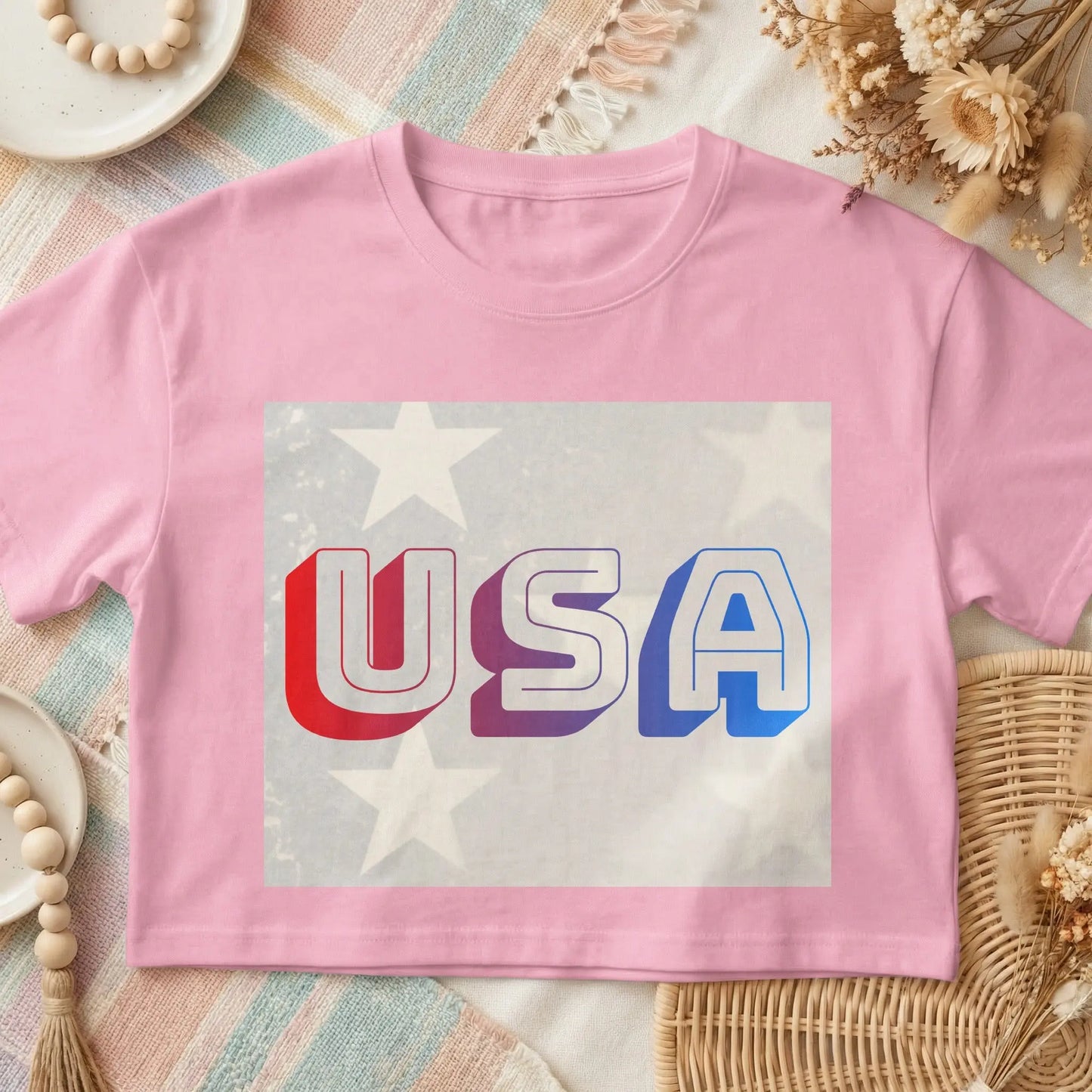 Pink t-shirt with "USA" text and American flag stars graphic.
