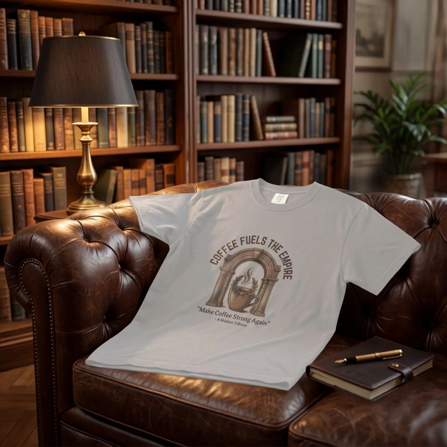 Light gray t-shirt with "Coffee Fuels the Empire" graphic on a leather couch.