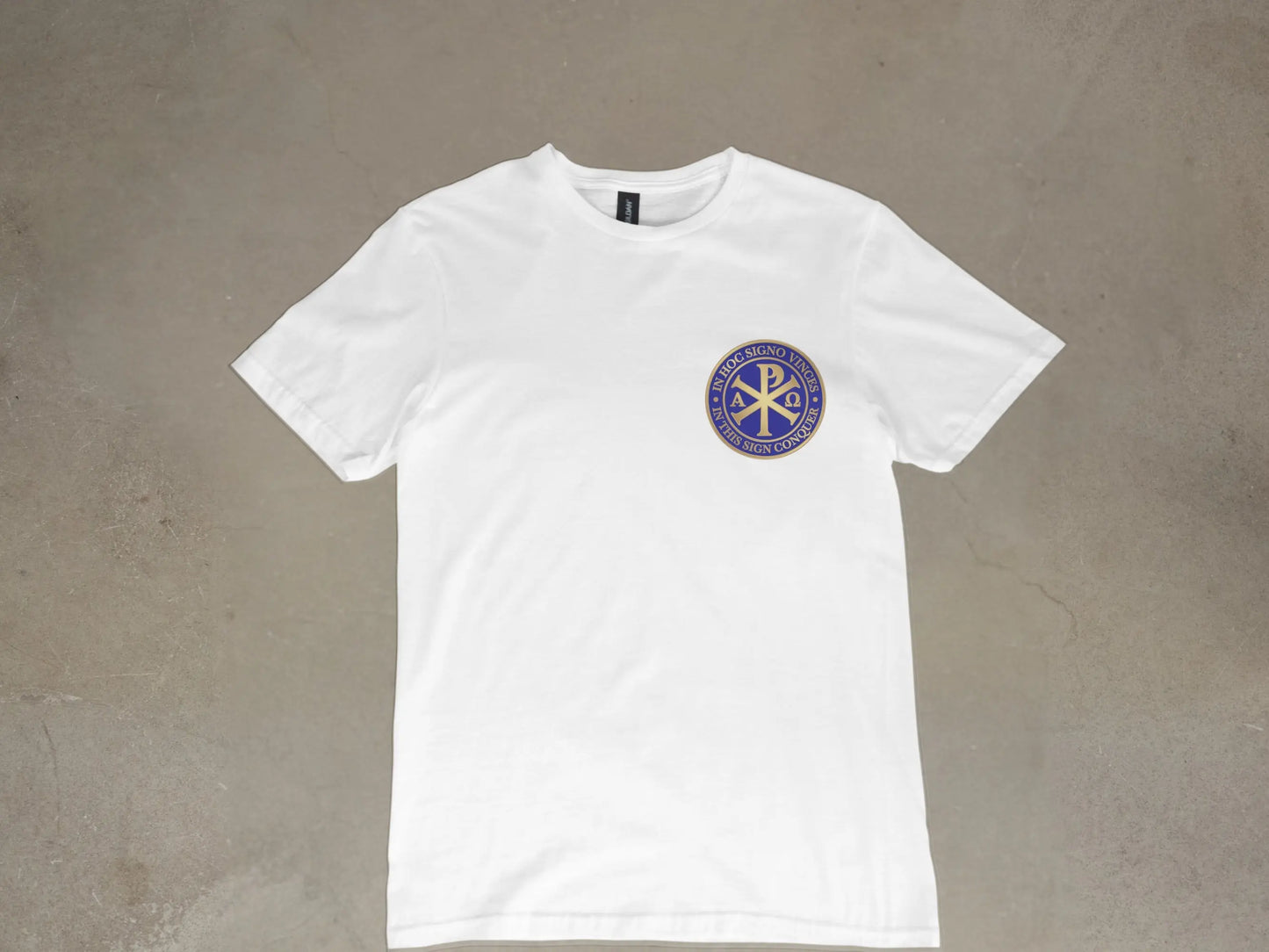 White t-shirt with circular emblem featuring Chi Rho symbol and Latin text.