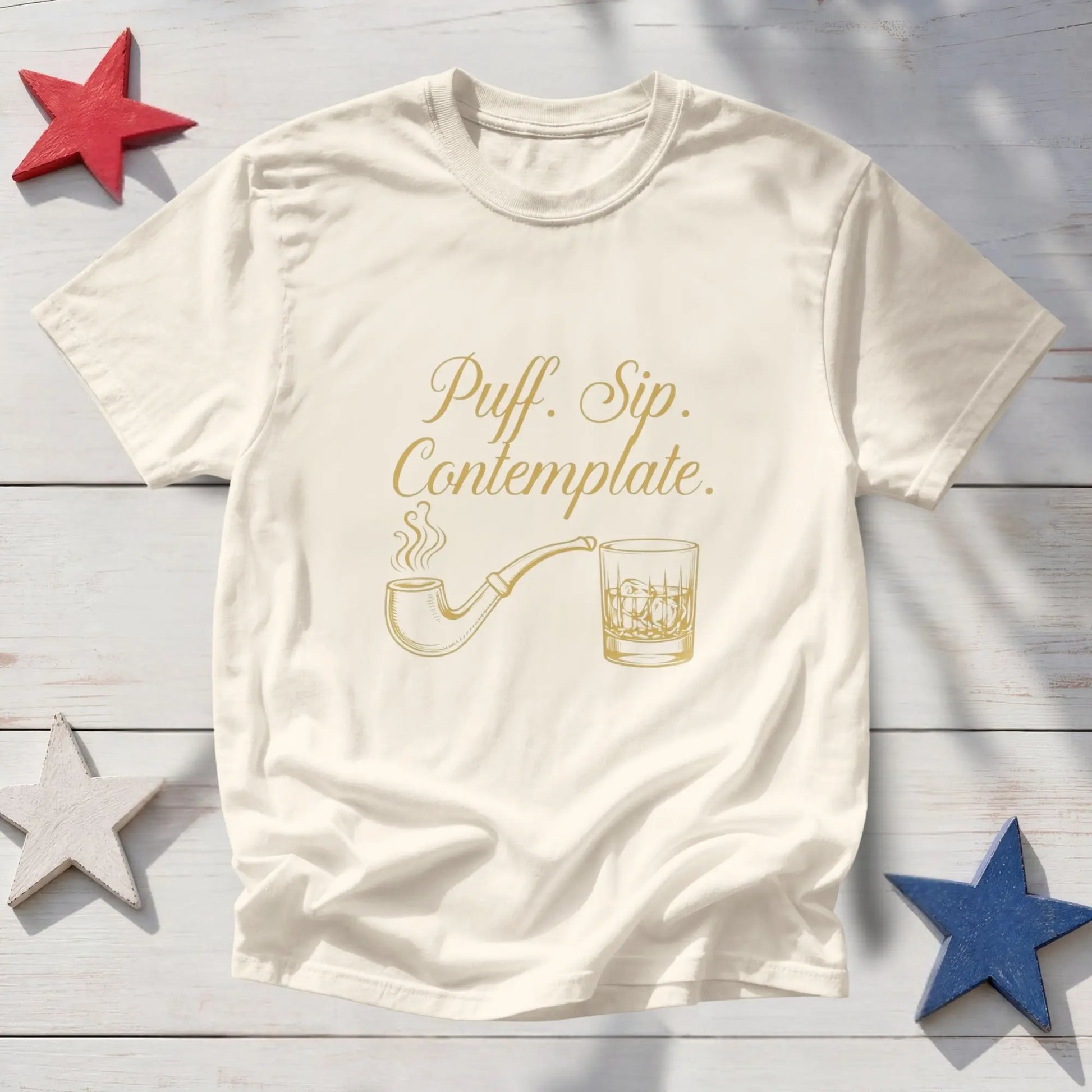 Cream t-shirt with gold text "Puff. Sip. Contemplate." and pipe and whiskey glass graphics.