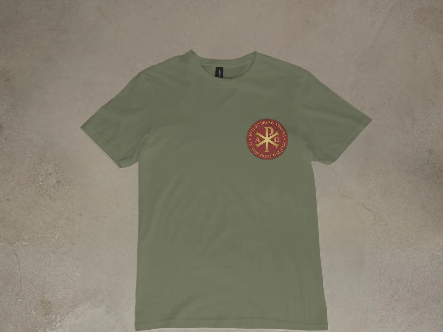 Olive green t-shirt with a circular crimson emblem on the left chest.